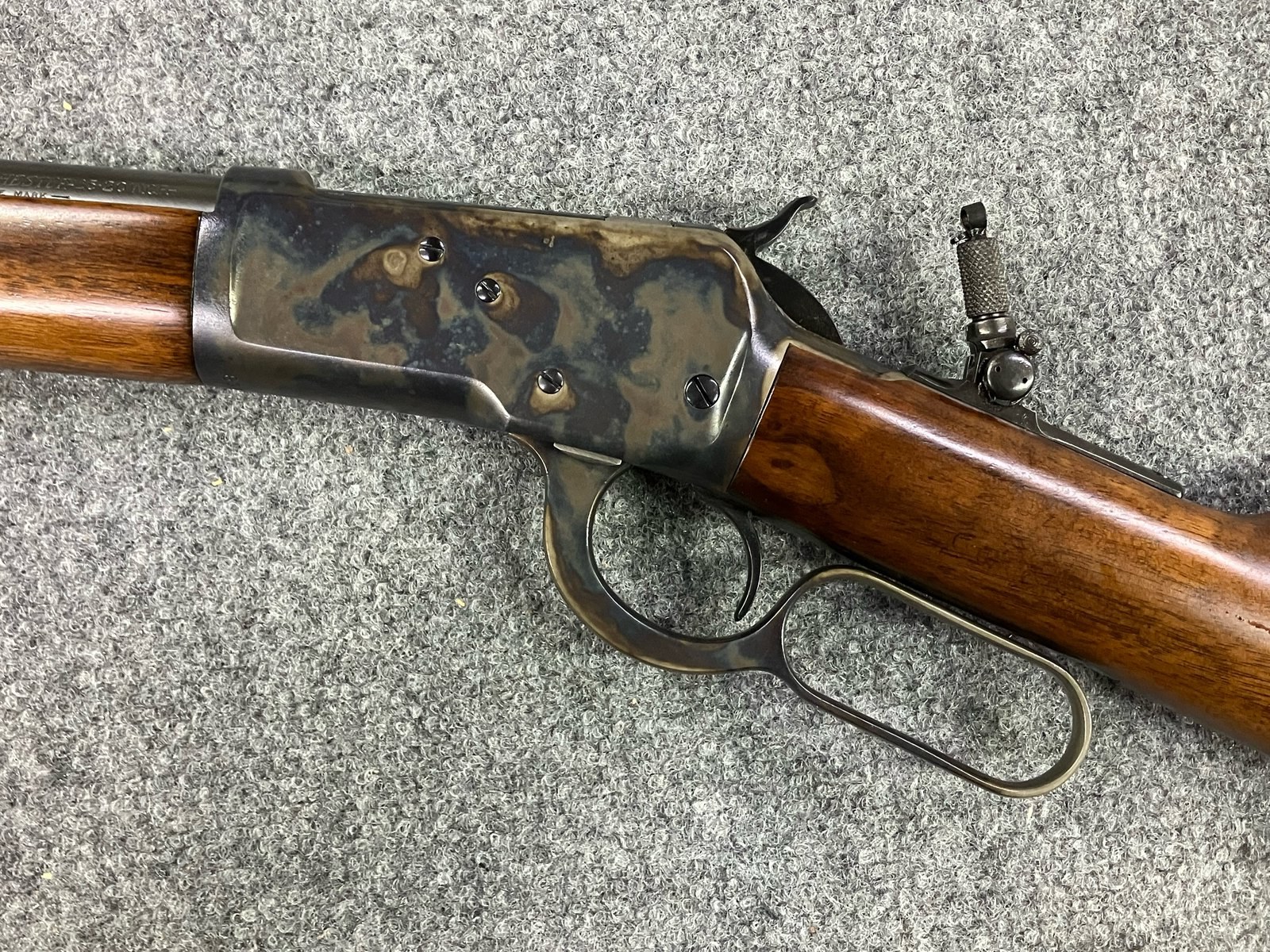 Color case-hardened lever-action receiver and lever, oriented left to right