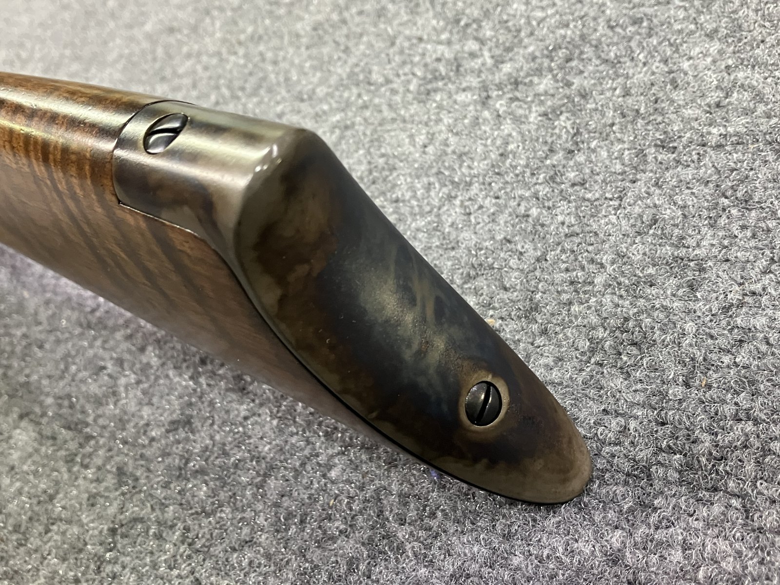 Color case-hardened buttplate on a figured wood stock