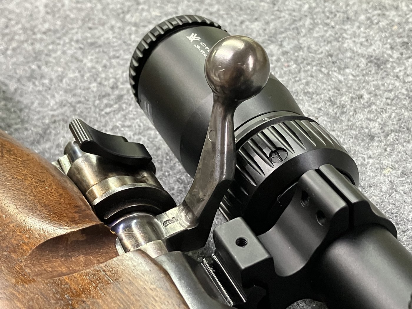 Close view of bent bolt knob clearance under the mounted scope