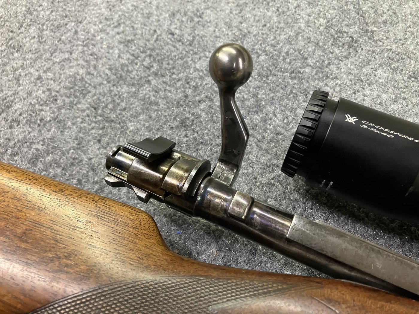 High-angle view of a rifle scope mounted on a Mauser-pattern action