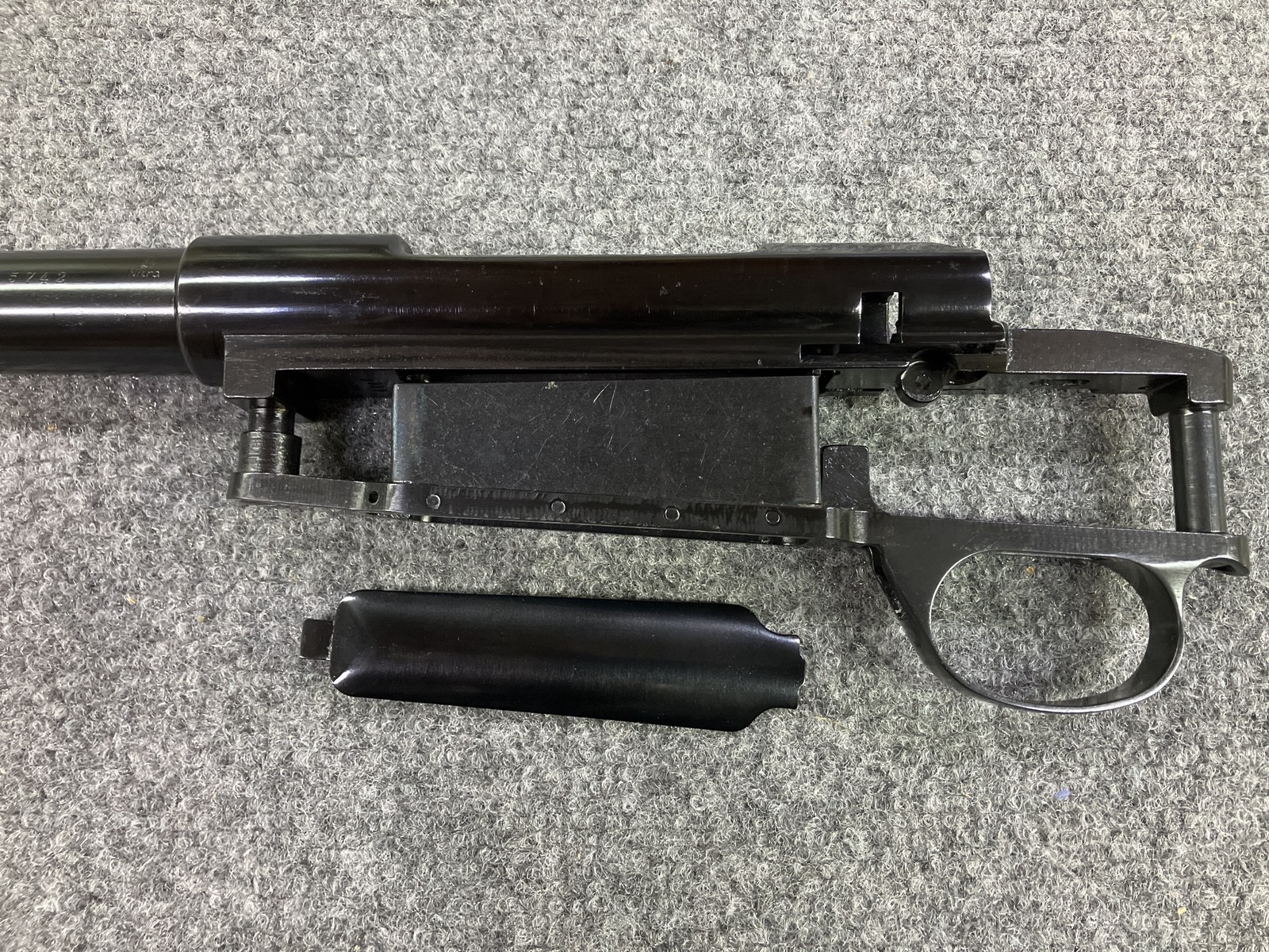 Husqvarna barreled action with shop hot-blued barrel and bottom metal next to factory receiver finish with a slight magenta cast