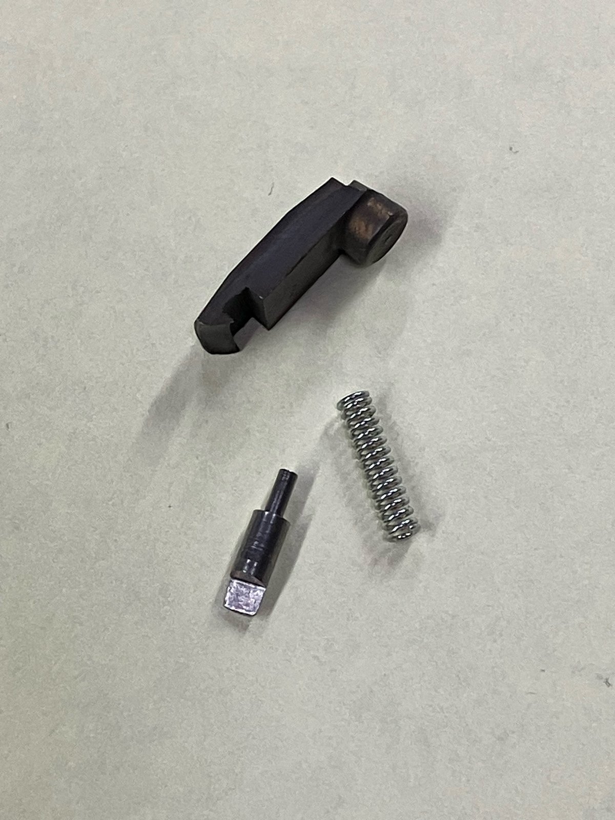 Sako-style extractor kit parts: claw, spring, and plunger