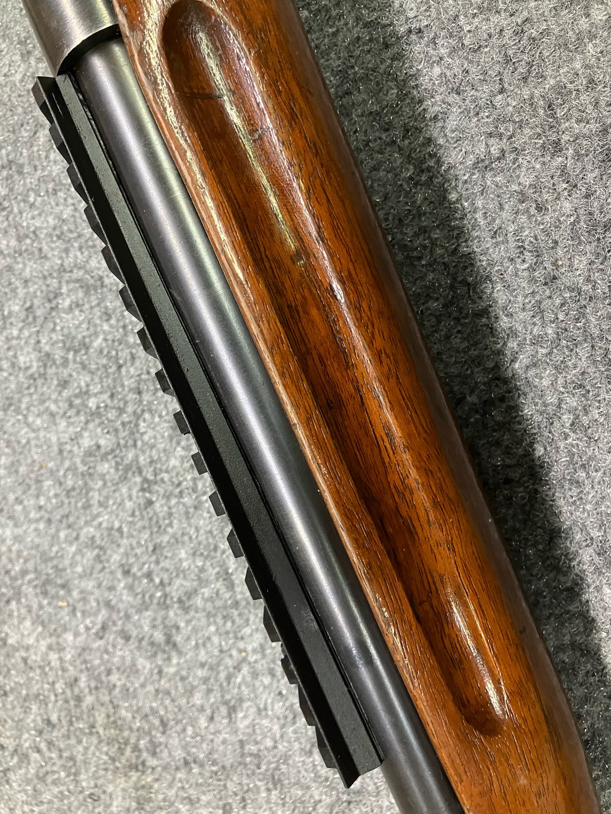 Close-up of a custom Picatinny scout rail on the forend of a sporterized Krag-Jorgensen, following the barrel contour