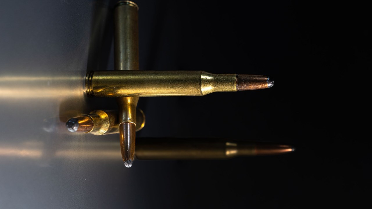 Rifle cartridges on a dark surface for ammunition evaluation