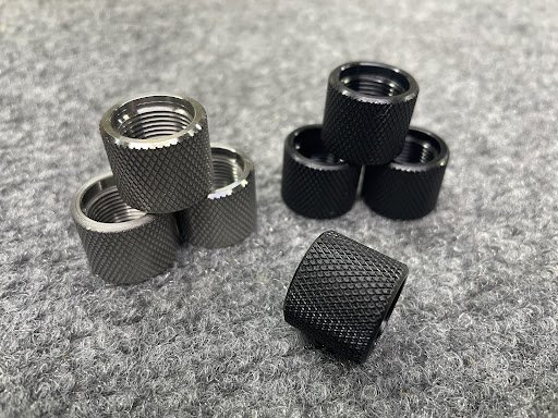 Stack of inexpensive knurled thread protectors in black finish