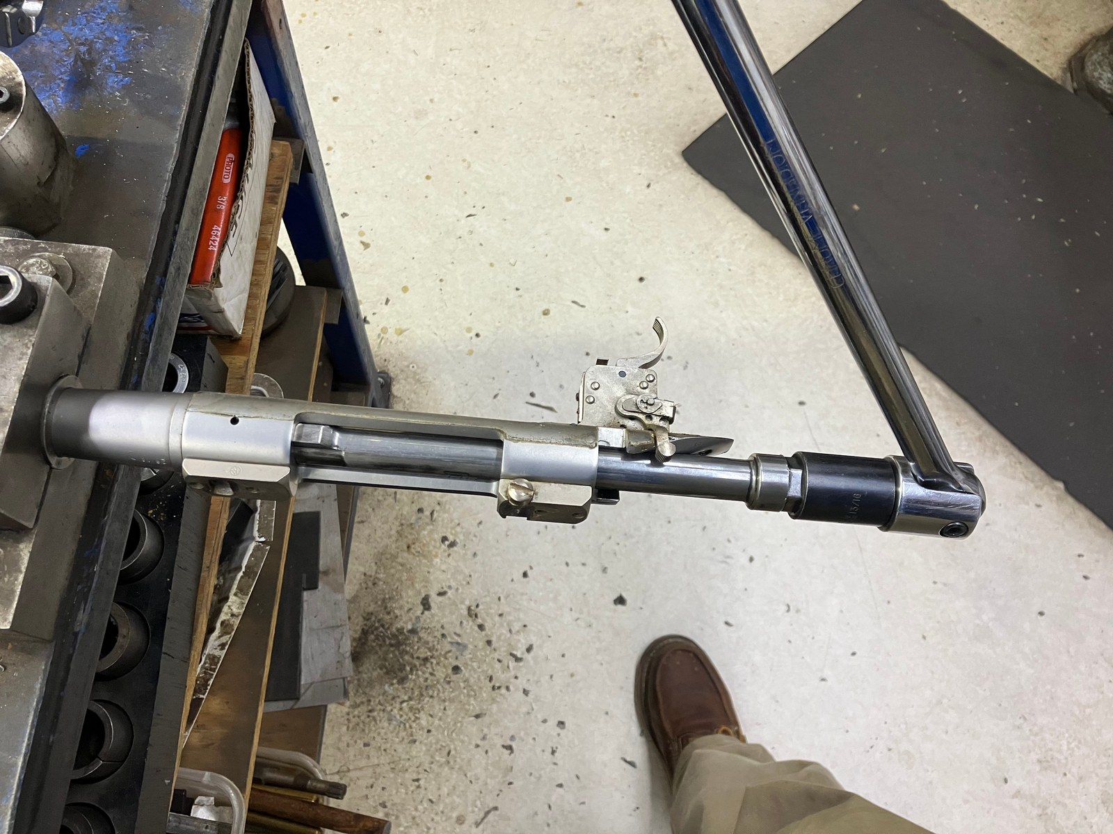 Barreled action held in a barrel vise after it was removed from the stock