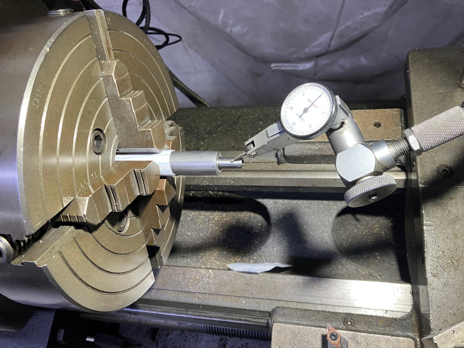 Indicating the muzzle end of a barrel in the lathe with a bore-diameter alignment rod
