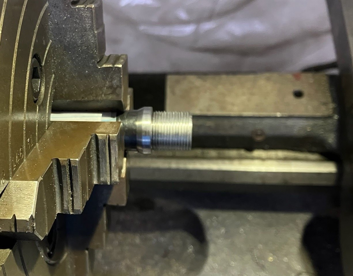 Shoulder-expanding collar turned down to the barrel diameter, with suppressor threads beyond the collar